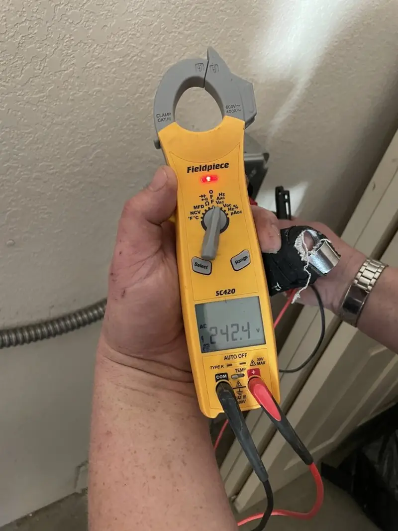 Voltage testing with clamp meter during Outlet Installation in Oak Hill